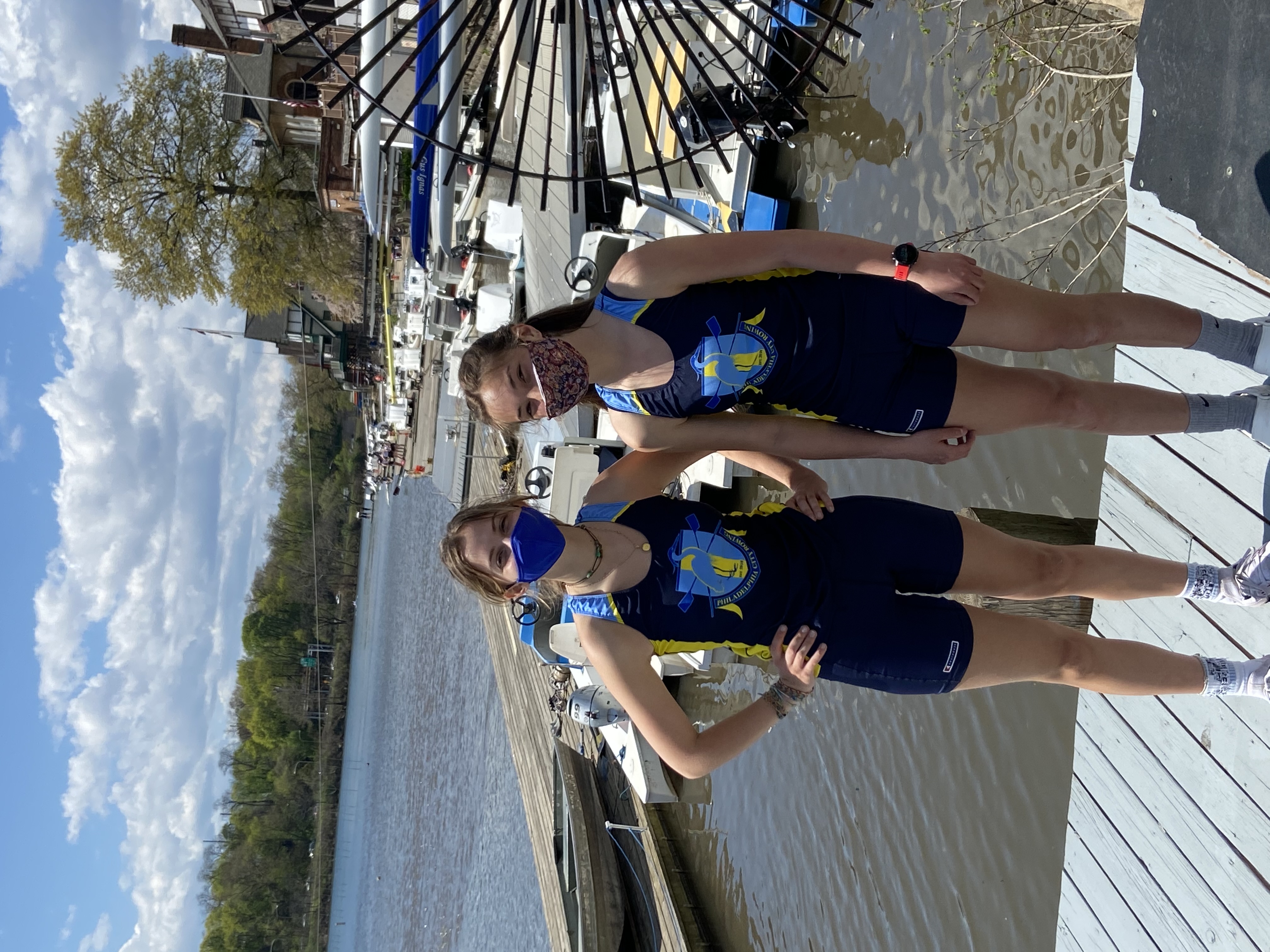 Two girls on dock after racing in the novice women's 2x
