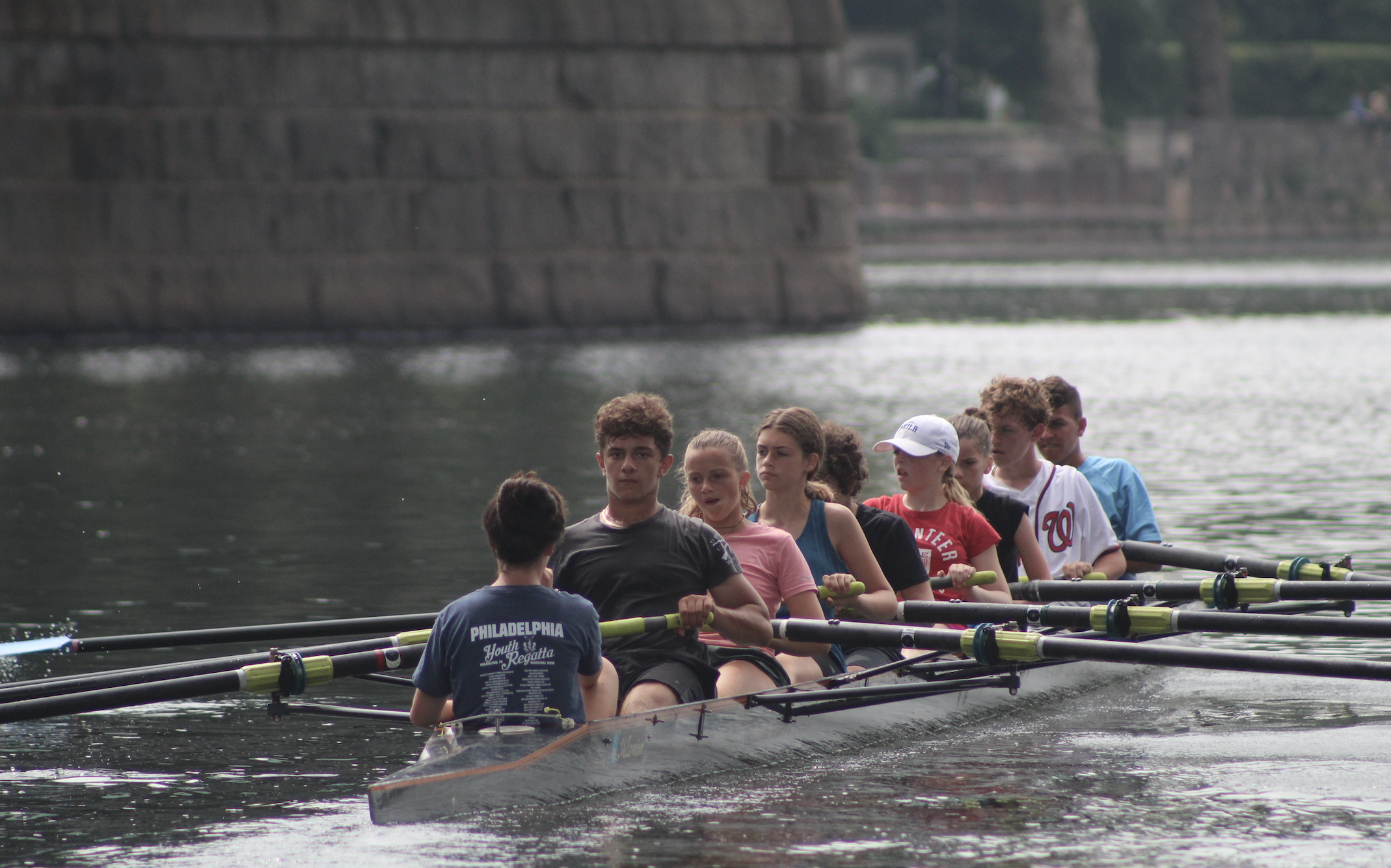 Eight rowing under bridge